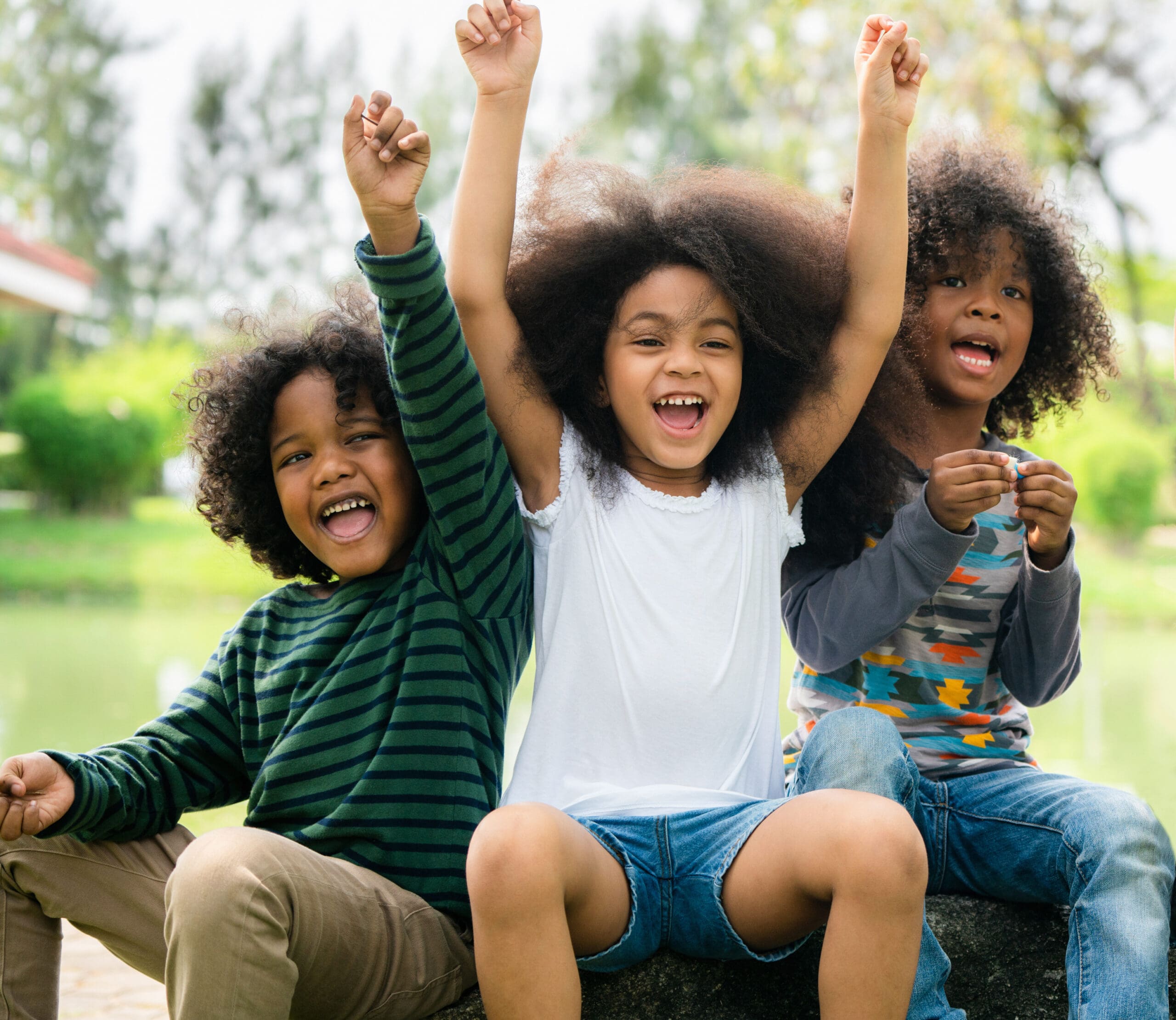 Happy African American boy and girl kids group playing in the playground in school. Children friendship and education concept.