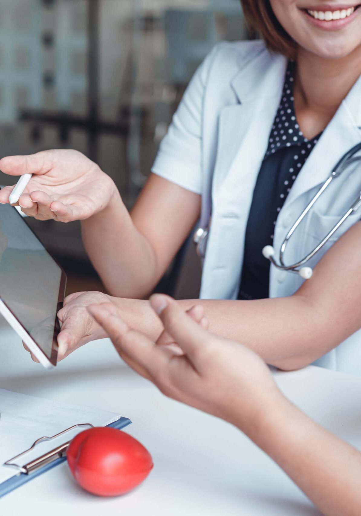 Professional doctor reporting medical results on mockup tablet white screen to male patient at clinic.Diagnostic, prevention of men diseases, healthcare, medical service, consultation, Medical technology concept.