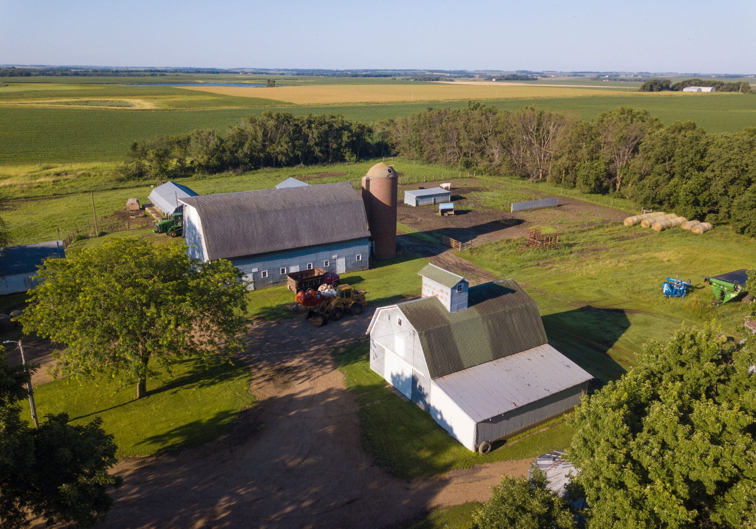 Aerial view of property released farm buildings in South Dakota with fields in the background.